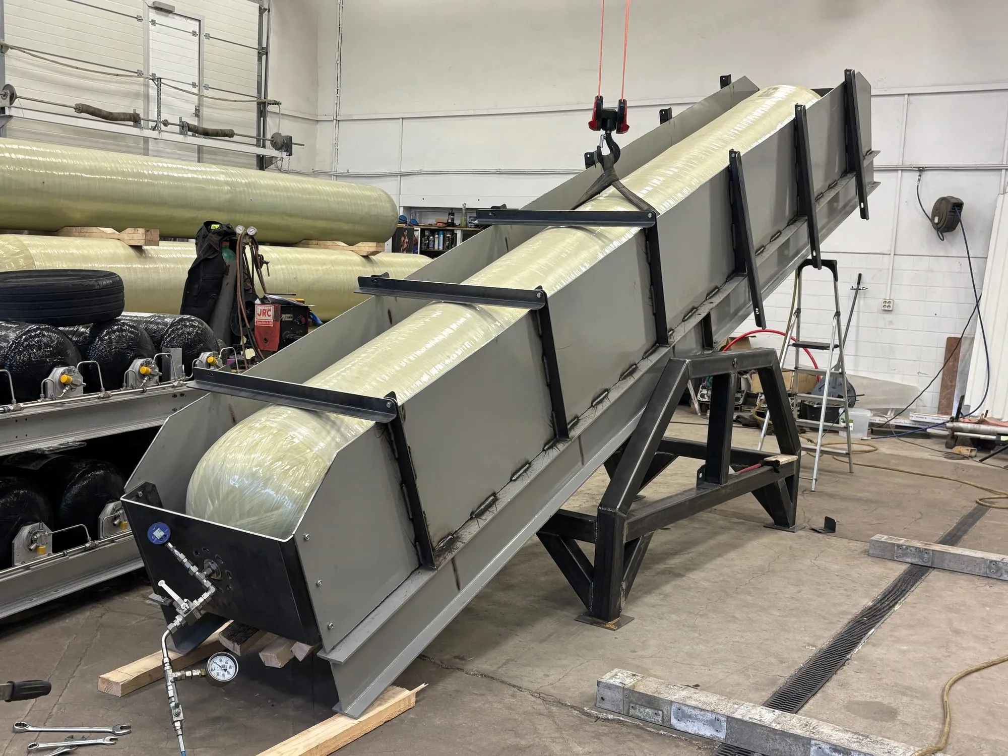 Composite pressure vessel seated in a steel cradle fabricated by Gaznet, gauge connected for testing