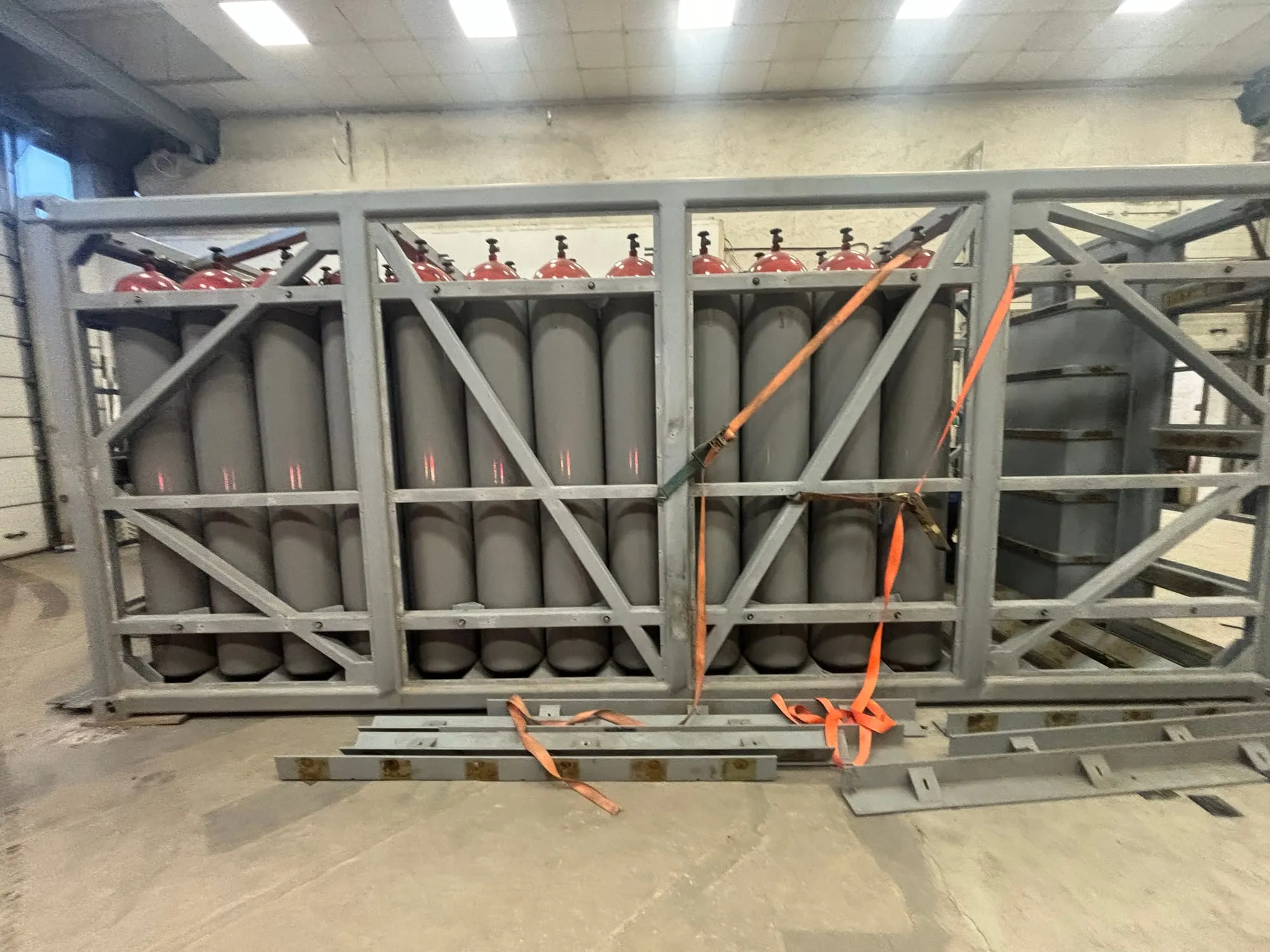 Cylinder pack lifted out of its container frame and set down in the workshop for inspection