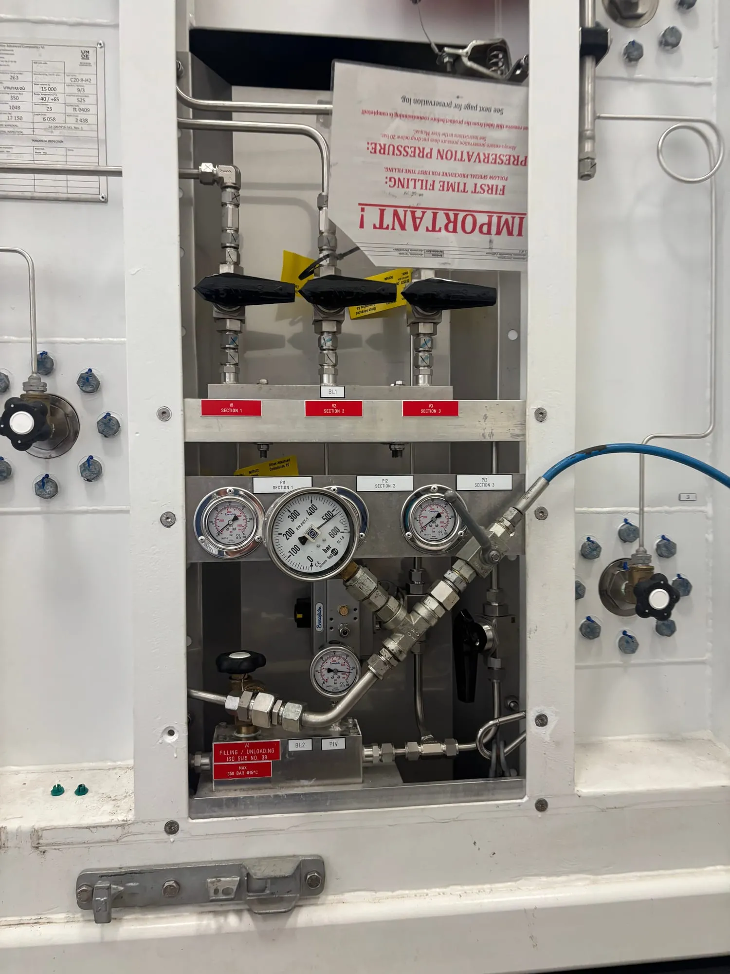 Manifold panel of a MEGC container with section valves and pressure gauges, opened for inspection